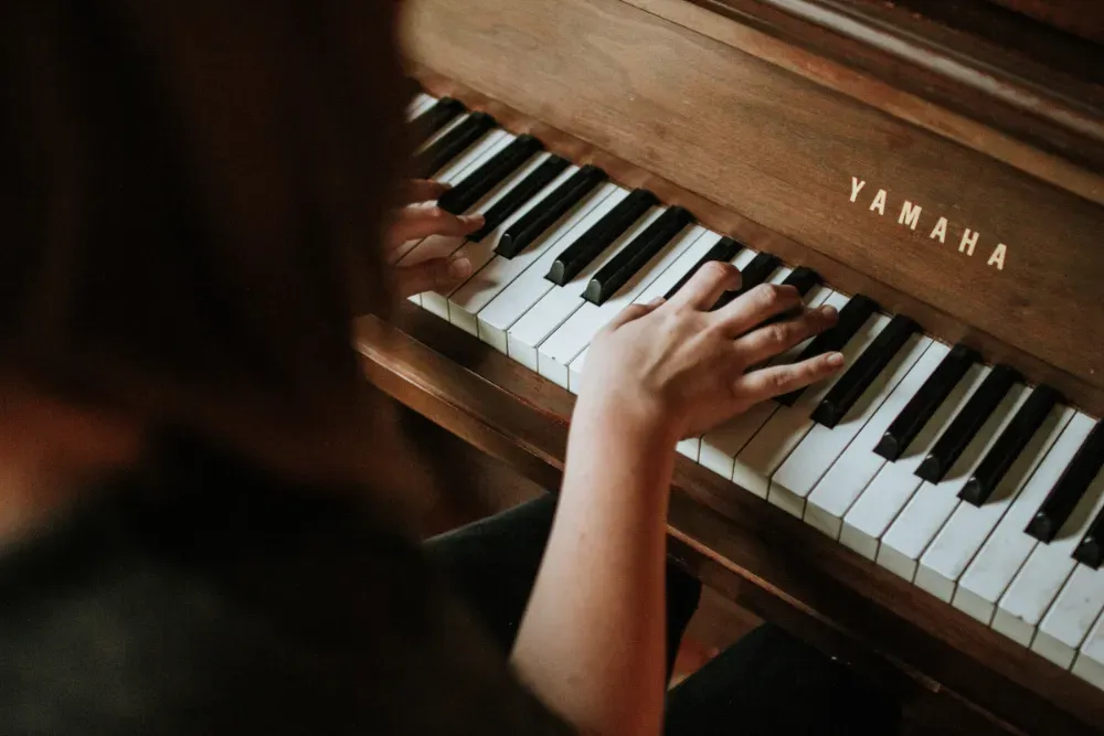 A teacher and student reviewing sheet music during an online lesson